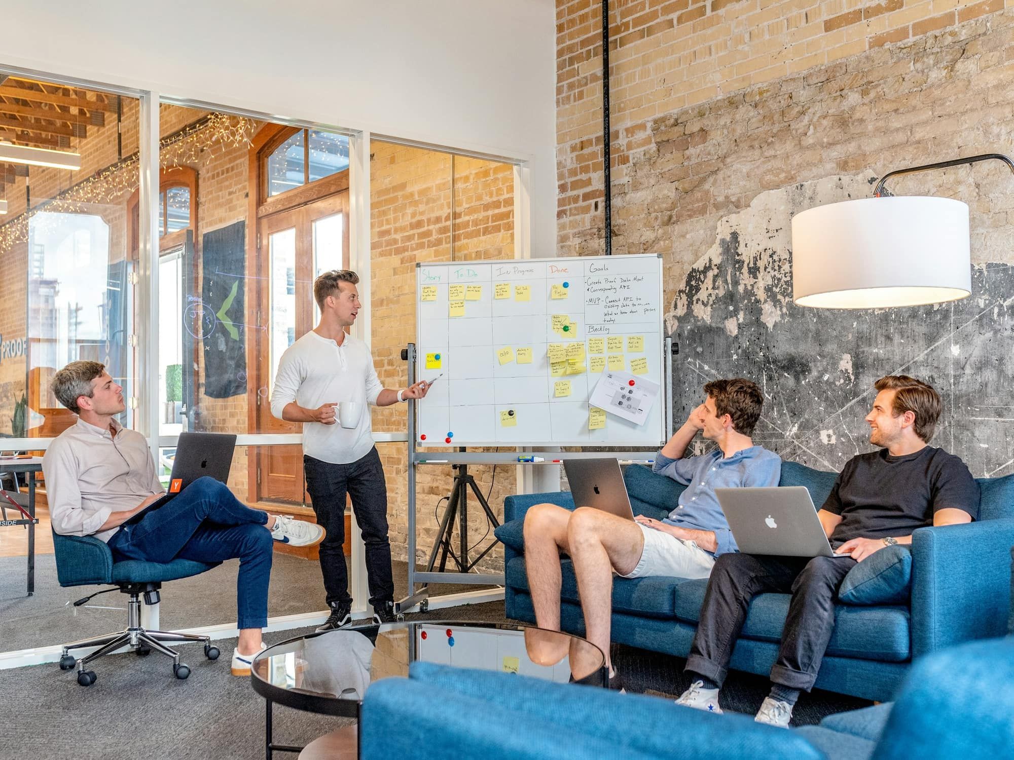 A small team planning a campaign around a whiteboard